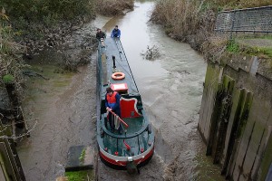 John Revell reverses Olive Emily into and through the Salters Lode sluice gate to join the Old Bedford river.