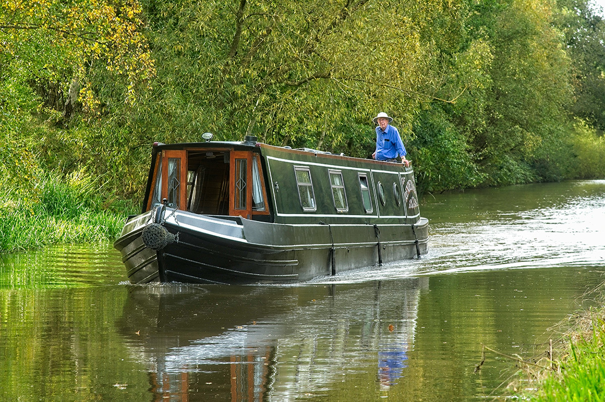 green canal boat cruising