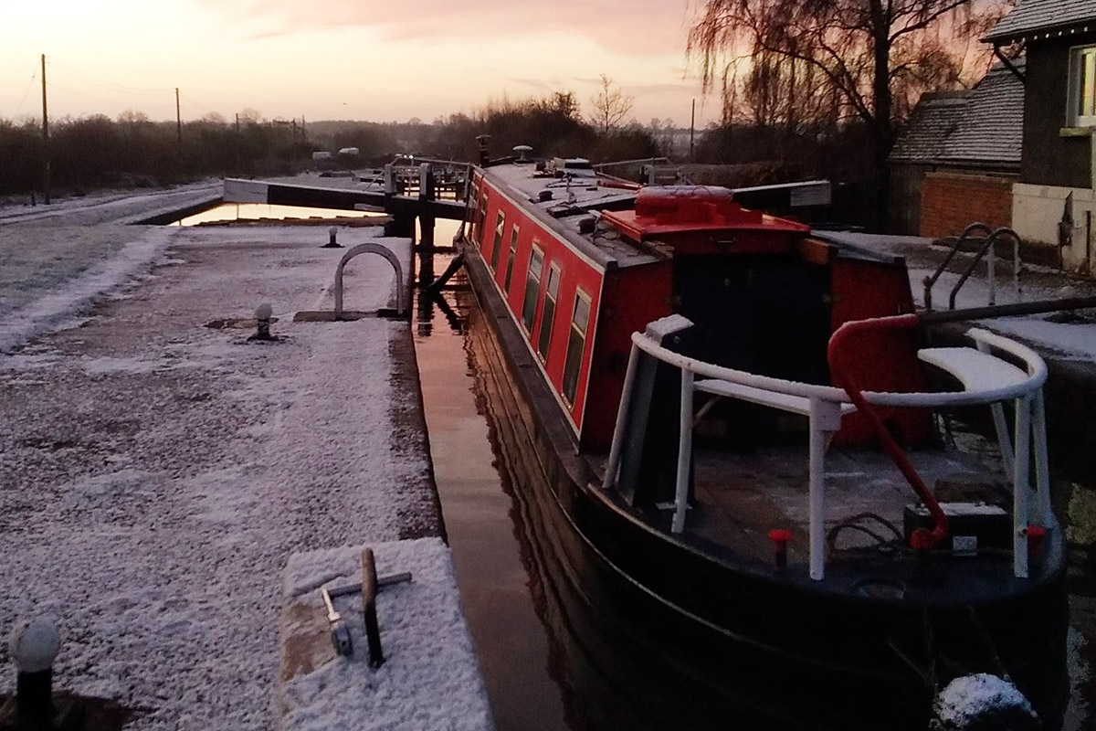 winter narrowboat passing lock alice elgie